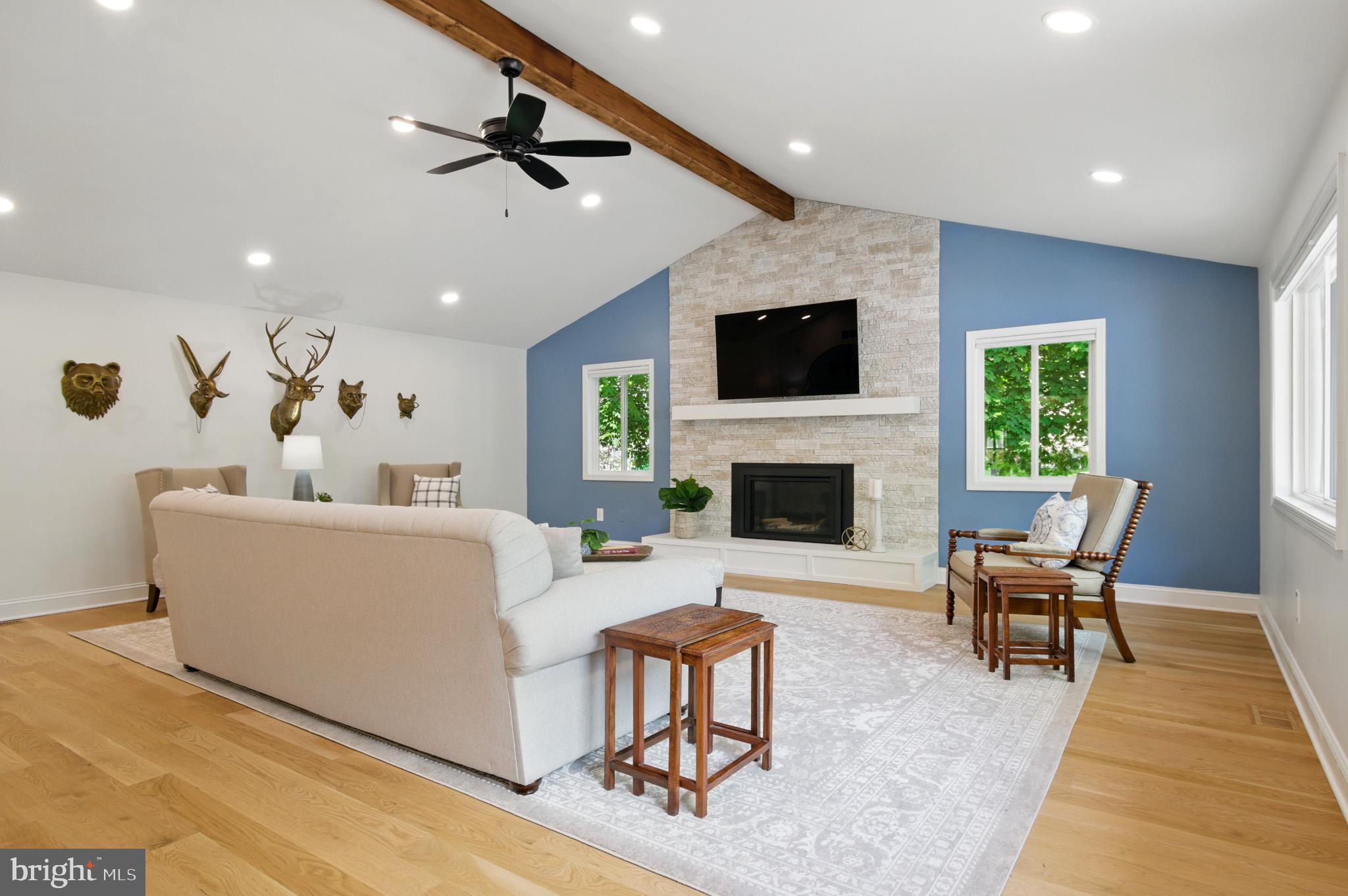 3633 Valley Road Ellicott City, MD 21042 - Photo 7 of 72 a living room with furniture a flat screen tv and a fireplace