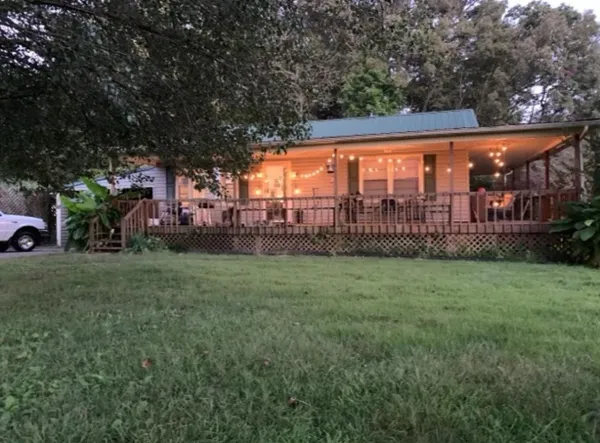 a front view of a house with a yard table and chairs