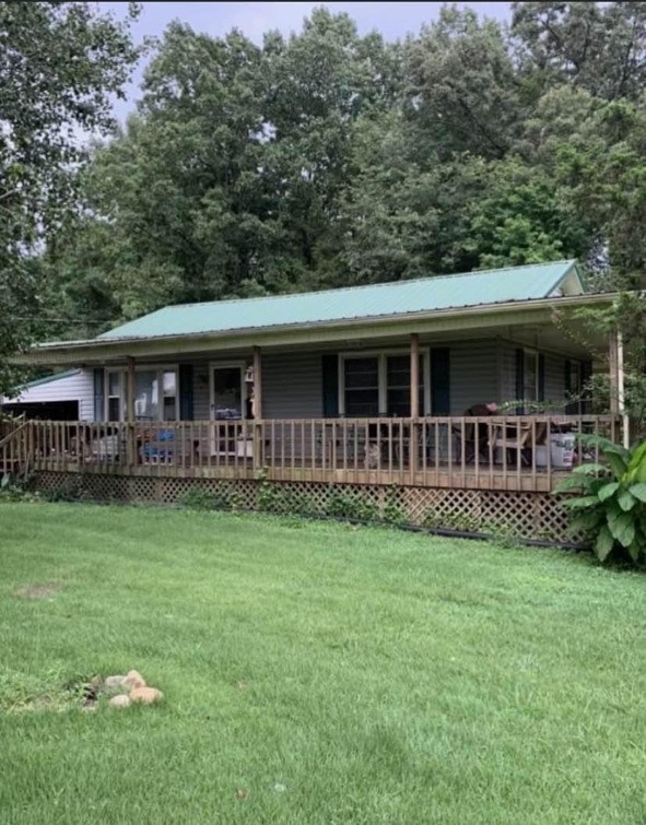 2058 Jefferson Road Smithville, TN 37166 - Photo 2 of 10 a front view of a house with a yard table and chairs