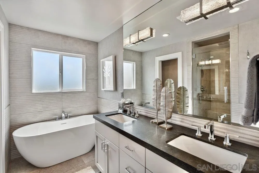 12 Mardi Gras Road Coronado, CA 92118 - Photo 38 of 70 a bathroom with a double vanity sink a mirror and a bathtub