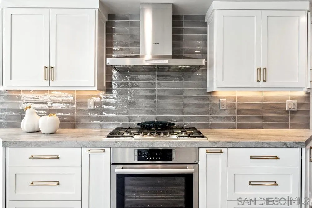 12 Mardi Gras Road Coronado, CA 92118 - Photo 5 of 70 a kitchen with stainless steel appliances granite countertop white cabinets and a stove