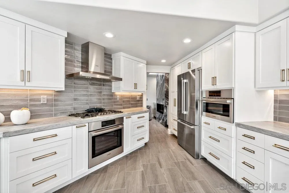 12 Mardi Gras Road Coronado, CA 92118 - Photo 6 of 70 a kitchen with stainless steel appliances a stove sink and refrigerator