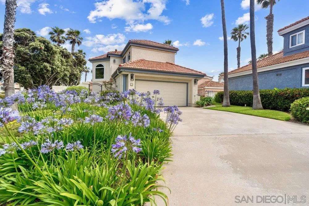 12 Mardi Gras Road Coronado, CA 92118 - Photo 61 of 70 a front view of a house with a yard and a fountain
