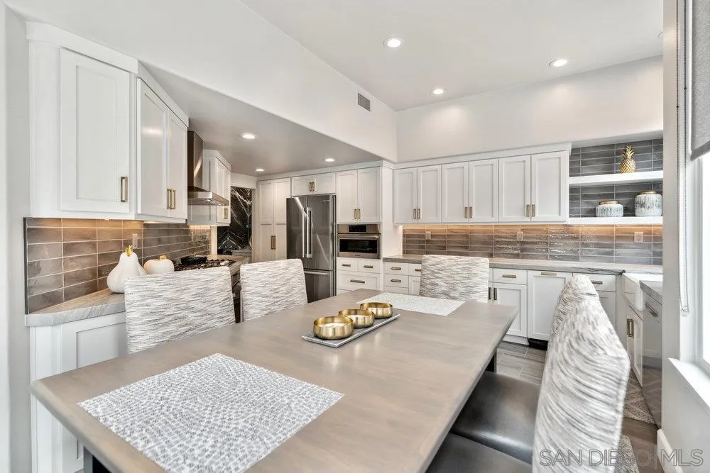 12 Mardi Gras Road Coronado, CA 92118 - Photo 9 of 70 a large kitchen with stainless steel appliances granite countertop a stove a sink a refrigerator and white cabinets with wooden floor