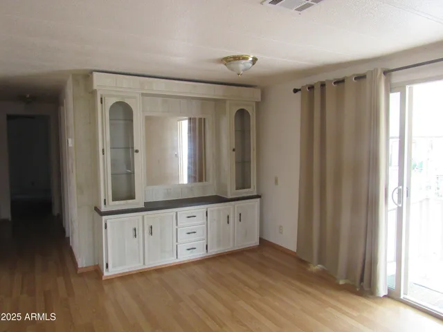a view of a bathroom with mirror and wooden floor