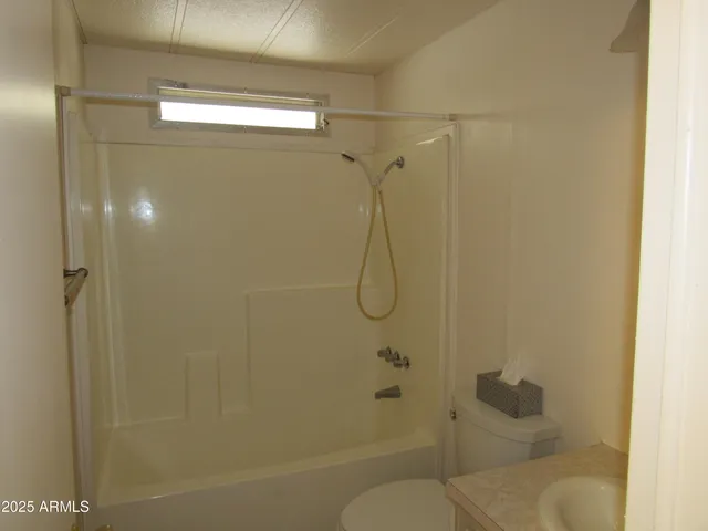 a bathroom with a shower and toilet