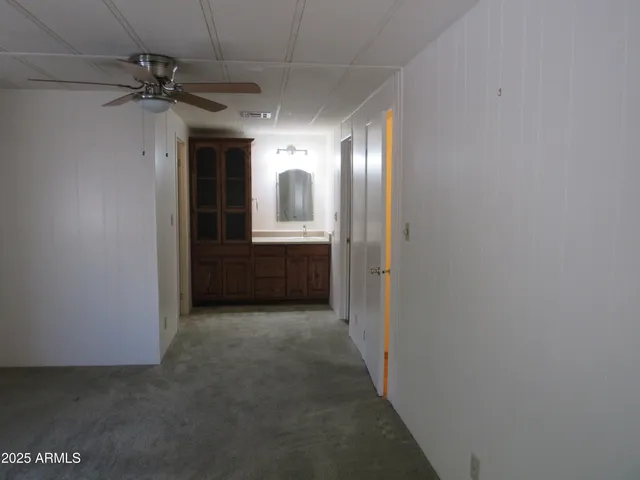 a view of hallway with chandelier and a window