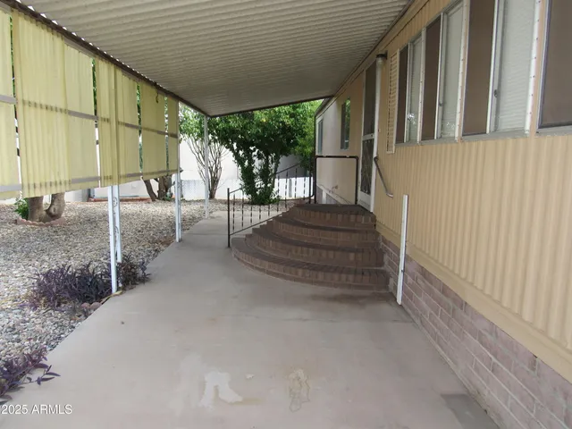a view of a house with backyard and porch