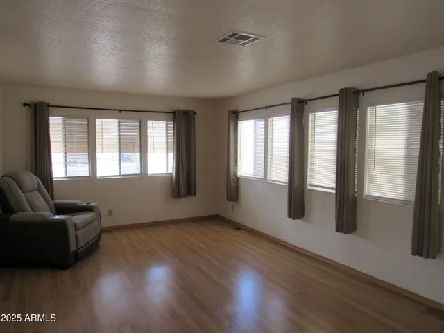a view of livingroom with furniture wooden floor and windows