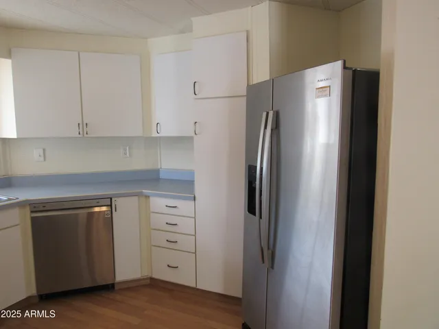a kitchen with cabinets and stainless steel appliances