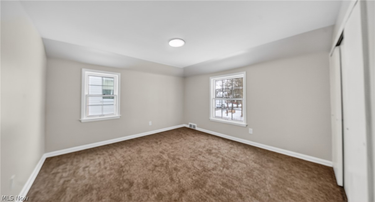 16811 Invermere Avenue Cleveland, OH 44128 - Photo 33 of 47 Unfurnished bedroom with a closet, carpet floors, and multiple windows