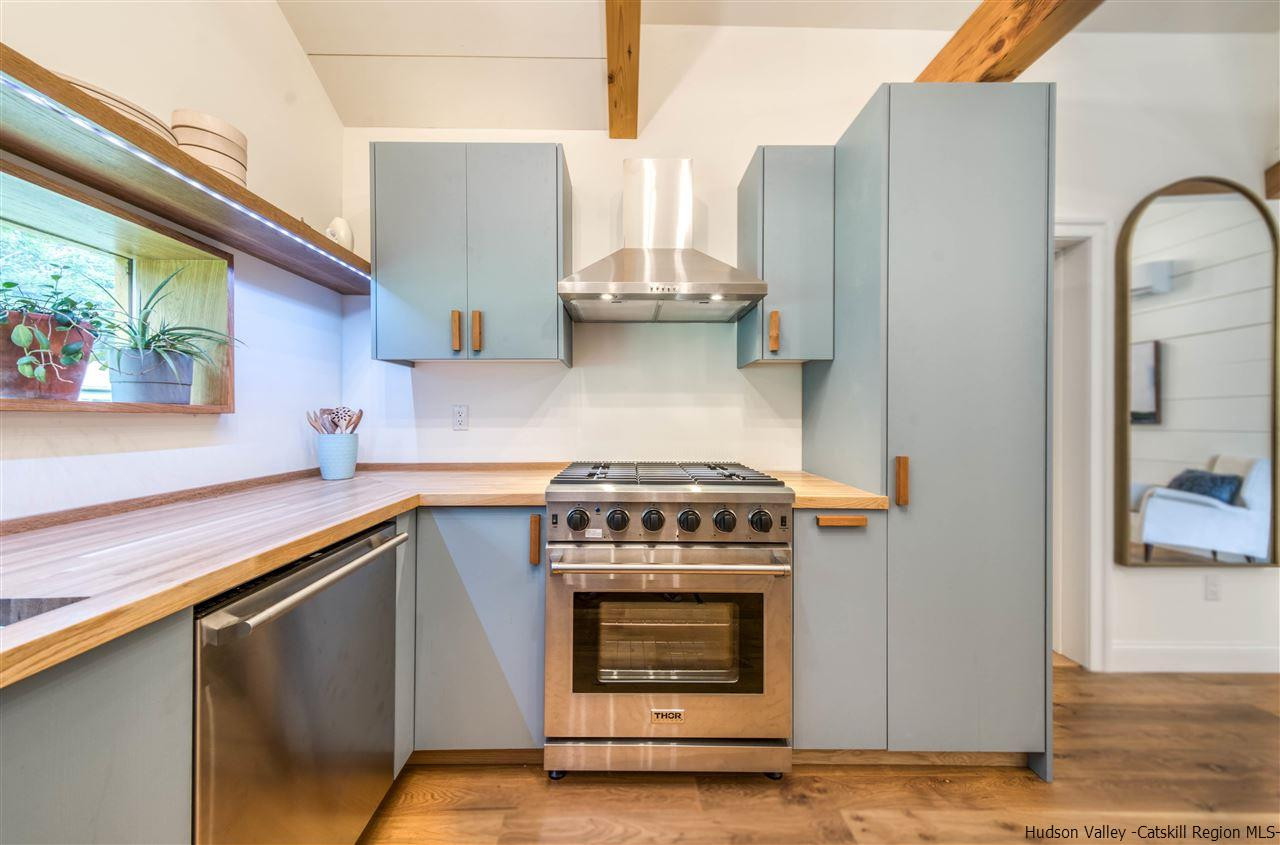 317 Sheldon Hill Road Olivebridge, NY 12461 - Photo 11 of 23 a kitchen with stainless steel appliances granite countertop a stove a sink and a refrigerator