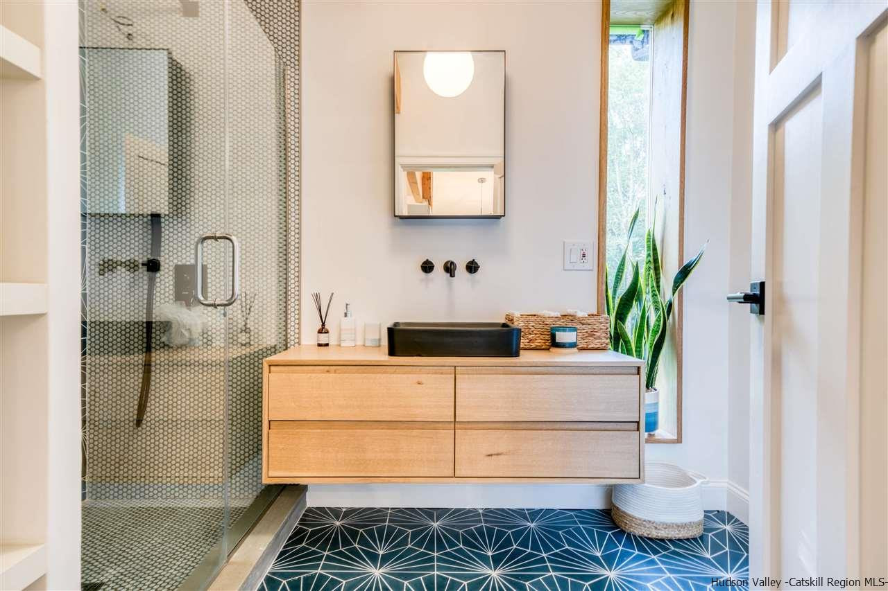 317 Sheldon Hill Road Olivebridge, NY 12461 - Photo 17 of 23 a bathroom with a granite countertop sink a toilet and shower