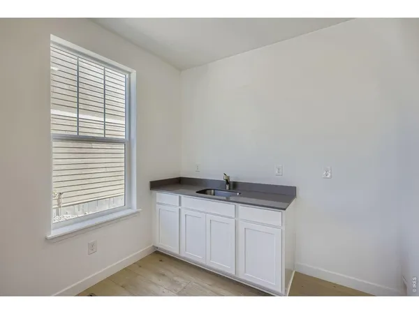 a kitchen with a sink cabinets and window