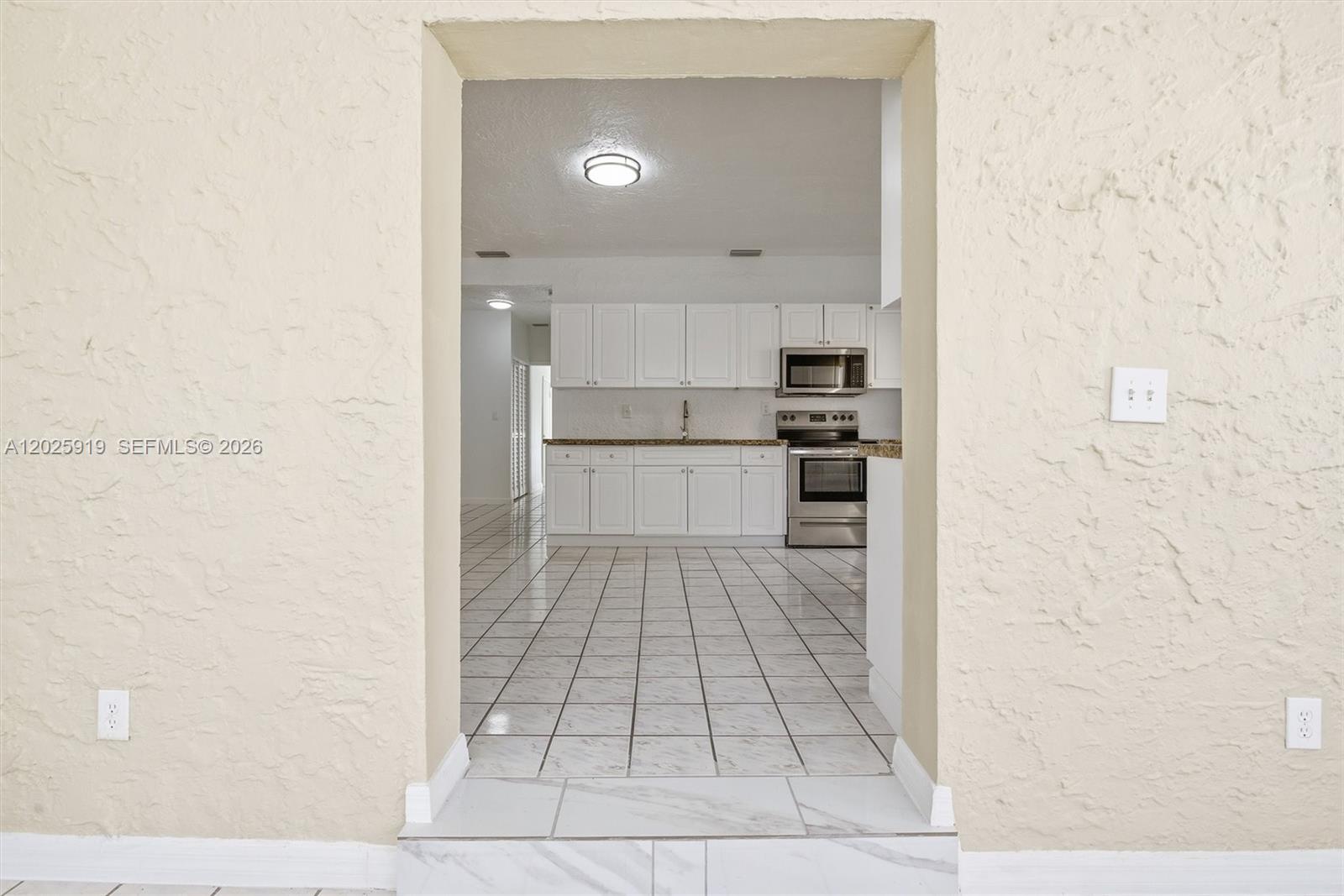 1743 Southwest 17th Street, Unit 1 Miami, FL 33145 - Photo 8 of 32 a large white kitchen with white cabinets
