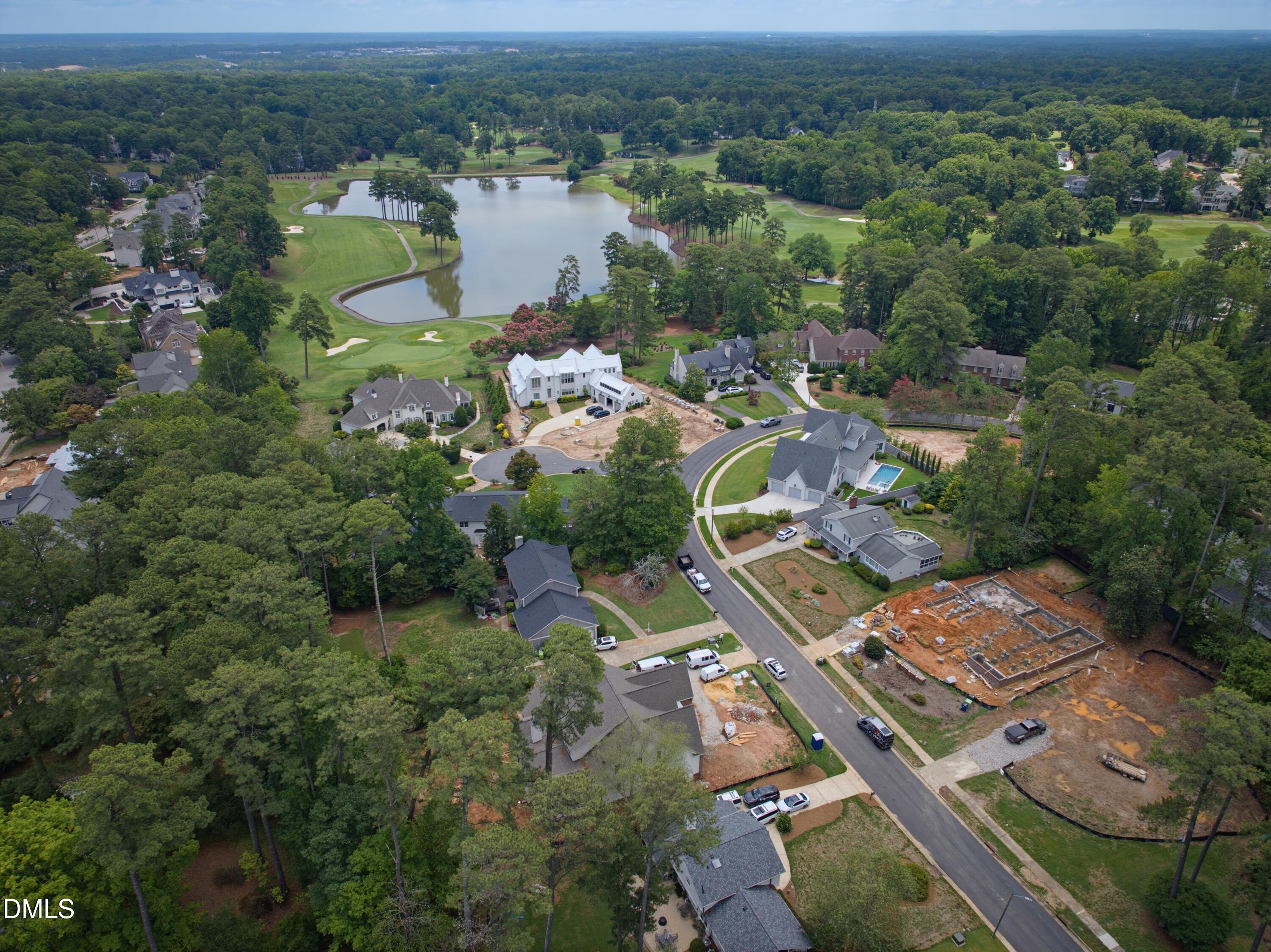 7508 Grist Mill Road Raleigh, NC 27615 - Photo 31 of 32 an aerial view of a house with a lake view