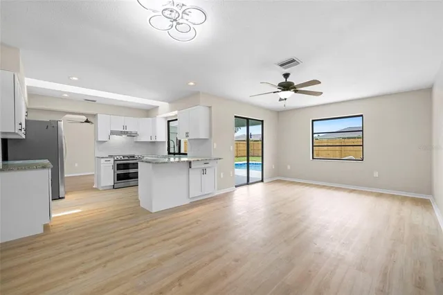 a view of kitchen with furniture and wooden floor