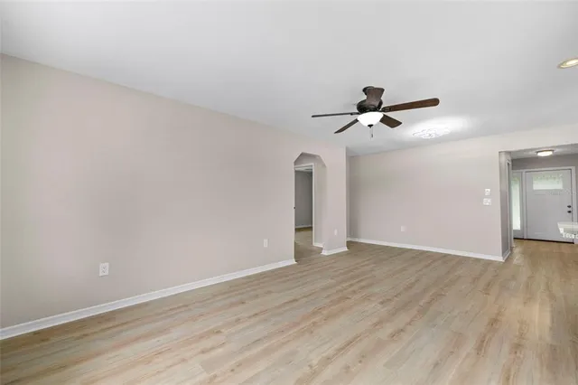 a view of an empty room and wooden floor