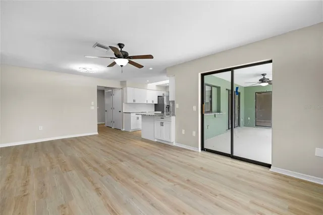 a view of a kitchen with a sink and cabinet with wooden floor