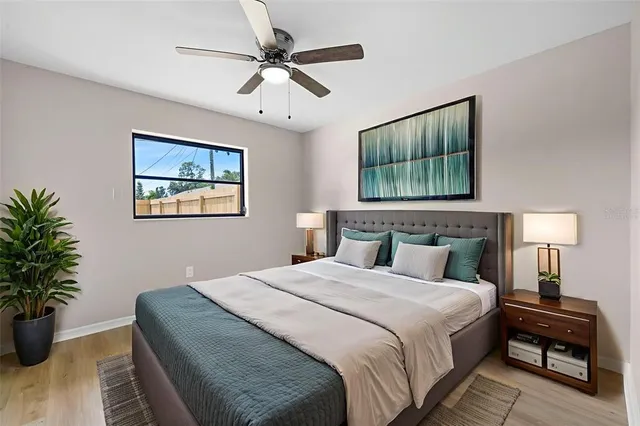 a bedroom with a large bed and a chandelier