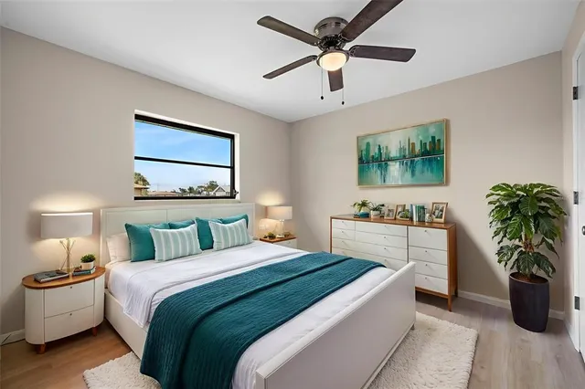 a bedroom with a large bed and a chandelier