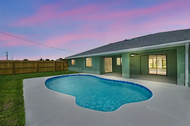 a view of a swimming pool with a yard