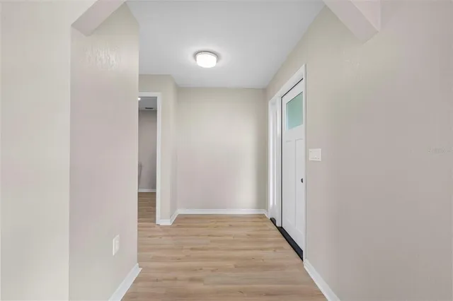 a view of a hallway with wooden floor