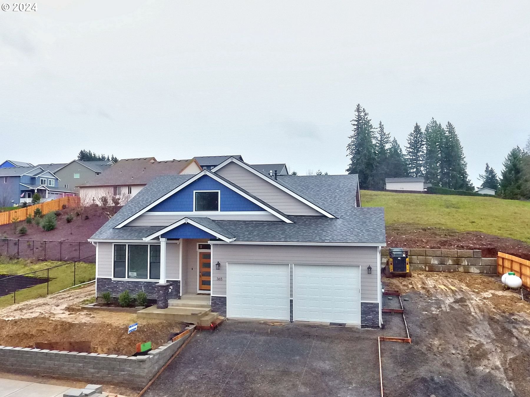 a front view of a house with a garden and yard