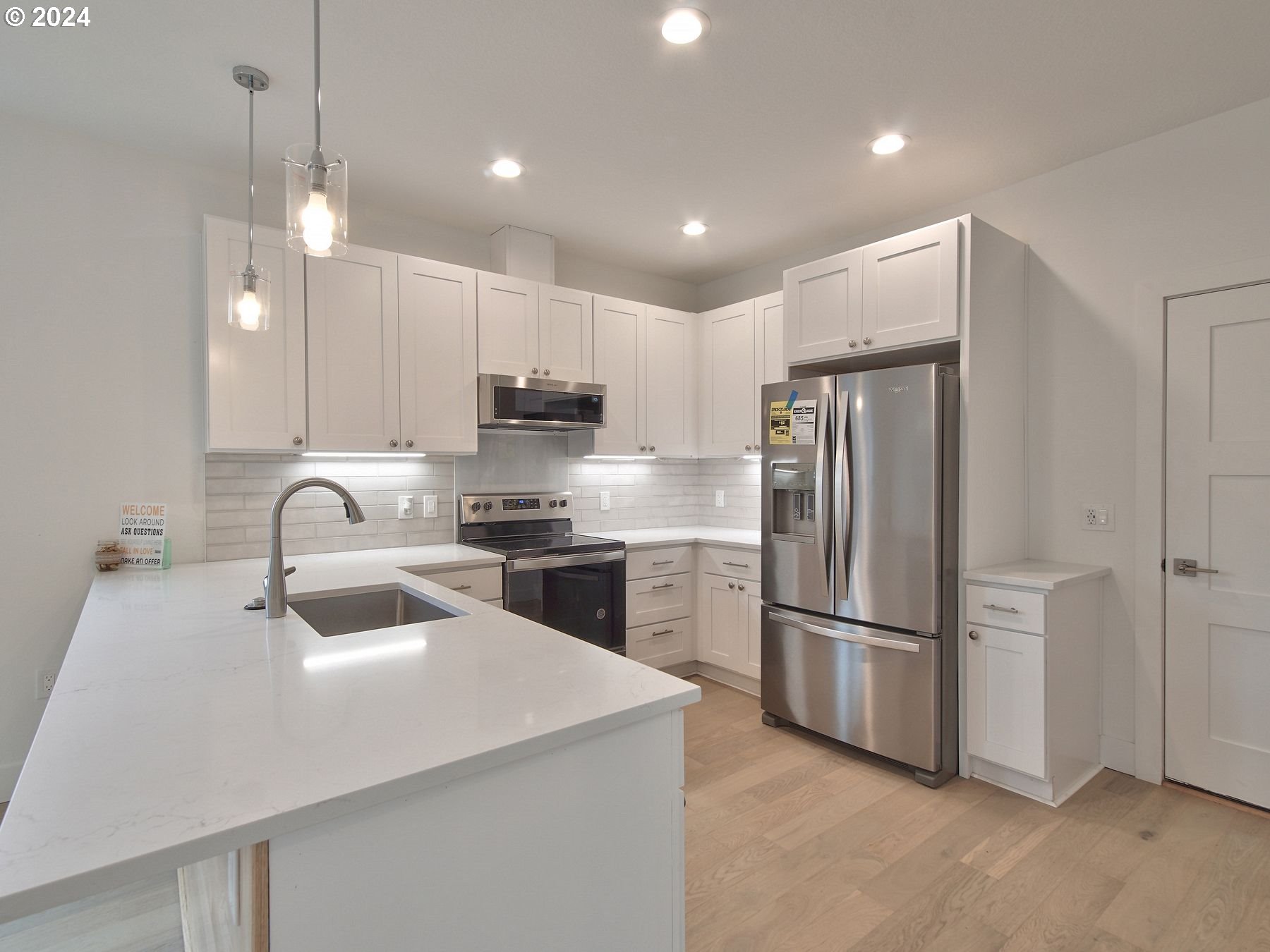 365 Northeast Oakview Drive Estacada, OR 97023 - Photo 12 of 39 a kitchen with kitchen island a sink stainless steel appliances and refrigerator