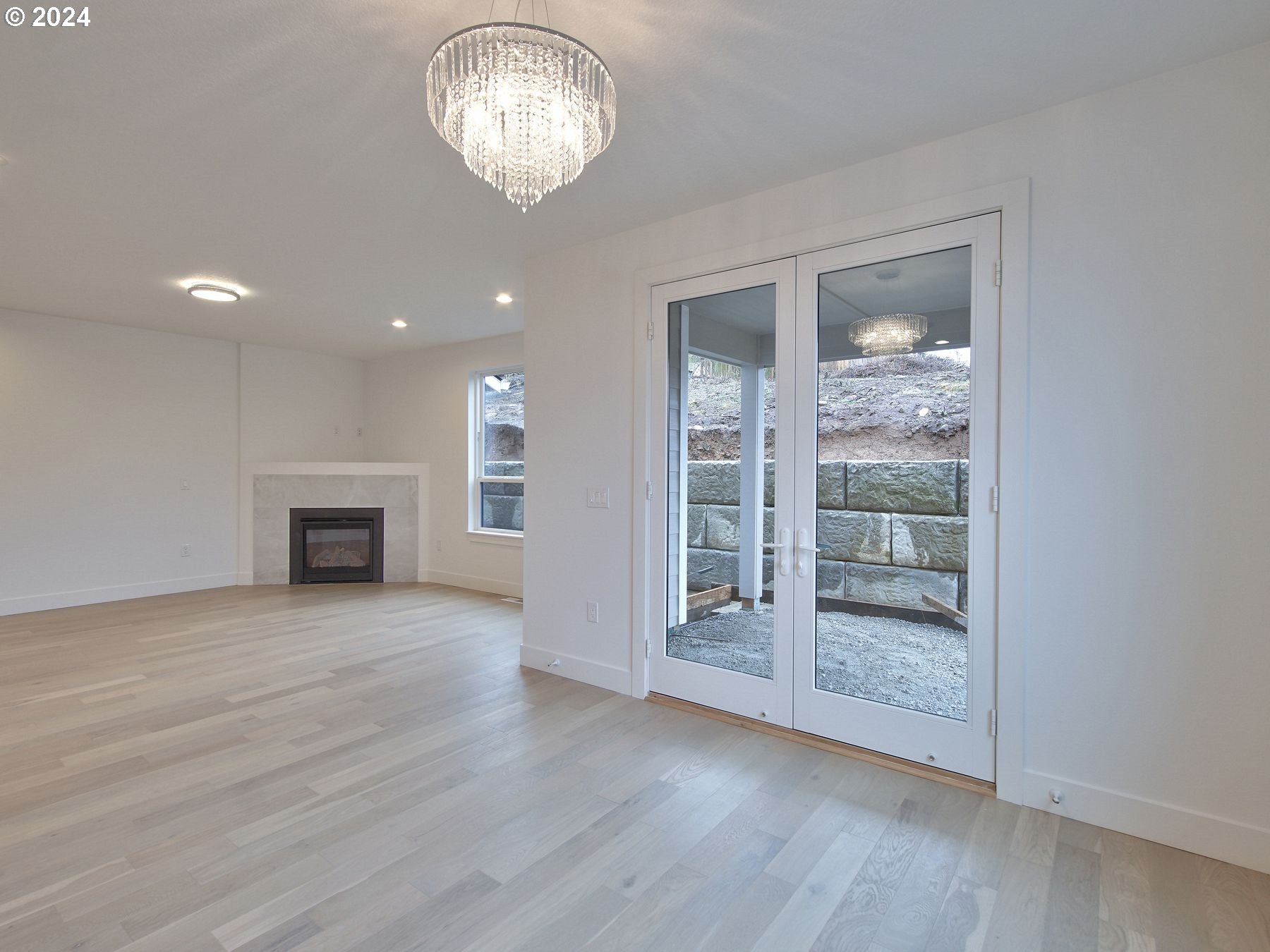 365 Northeast Oakview Drive Estacada, OR 97023 - Photo 18 of 39 an empty room with wooden floor fan and windows