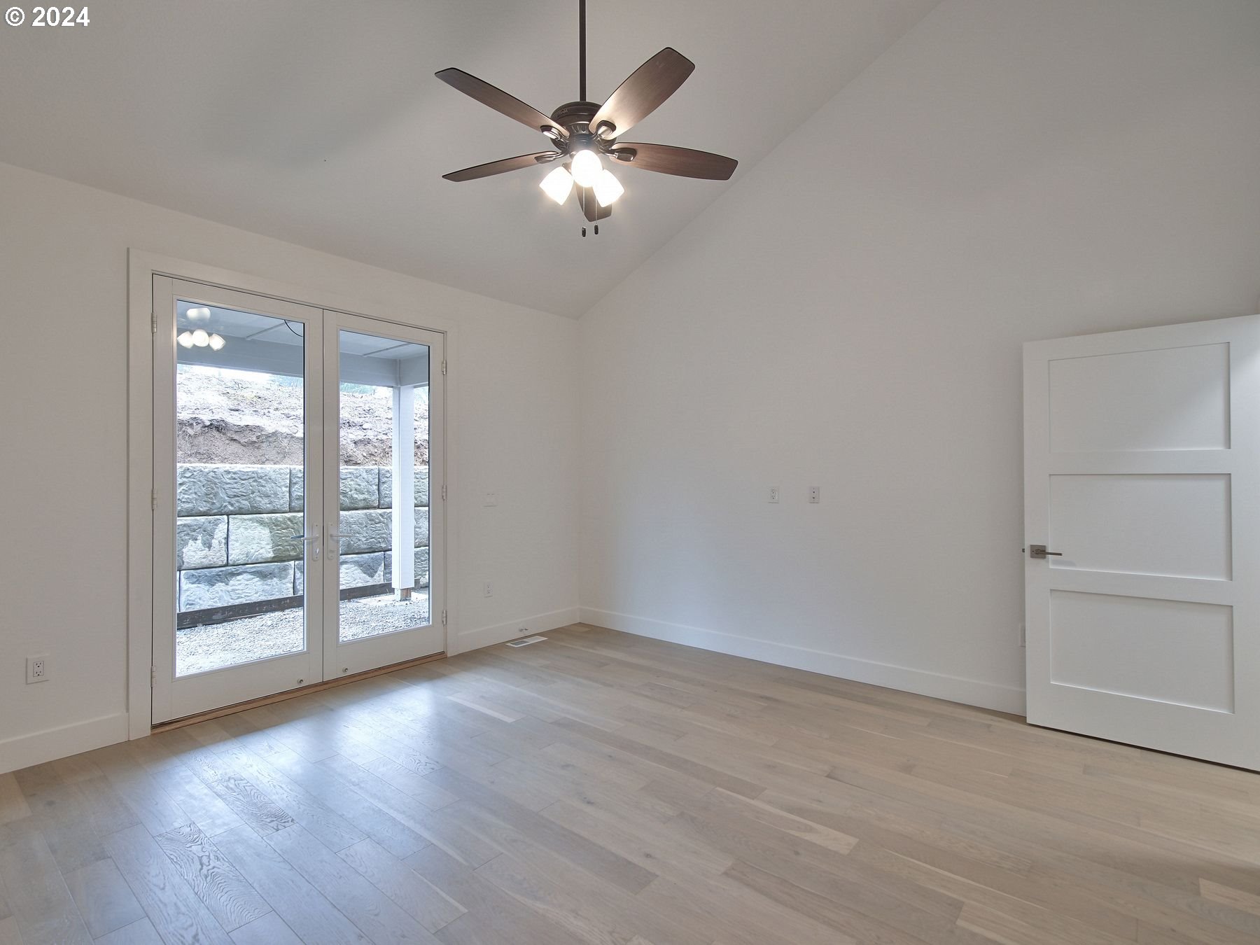 365 Northeast Oakview Drive Estacada, OR 97023 - Photo 20 of 39 an empty room with wooden floor fan and windows