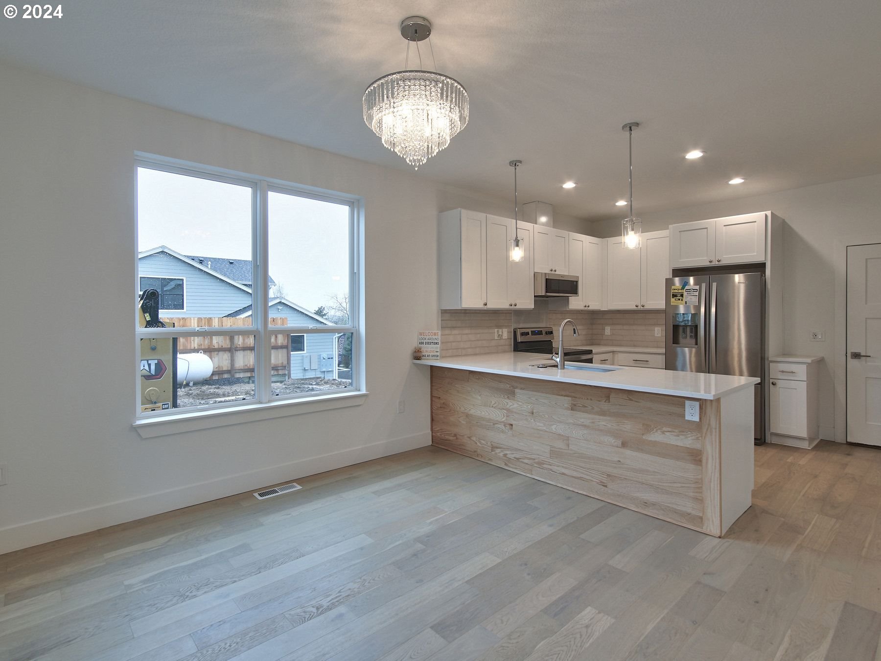 365 Northeast Oakview Drive Estacada, OR 97023 - Photo 10 of 39 a large kitchen with kitchen island white cabinets and stainless steel appliances