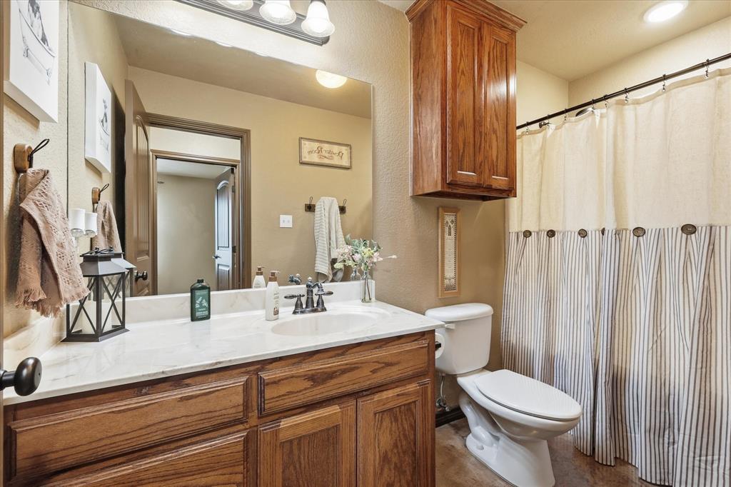 171 Ridge Top Drive Decatur, TX 76234 - Photo 21 of 40 a bathroom with a granite countertop sink toilet and shower