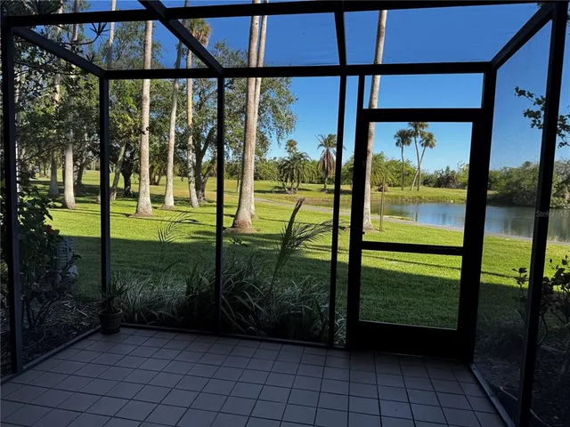 a view of a porch with a floor to ceiling window and wooden fence