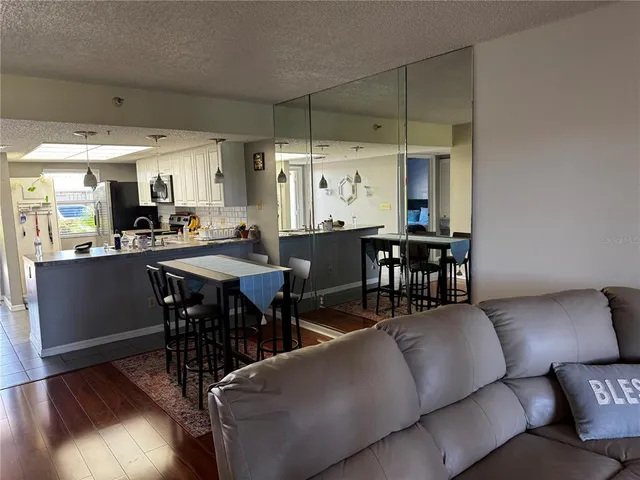 a living room with furniture a dining table and chairs