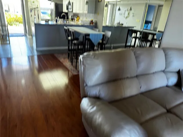 a dining room with furniture and wooden floor