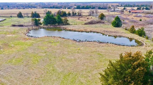 an aerial view of a house with a yard and lake view