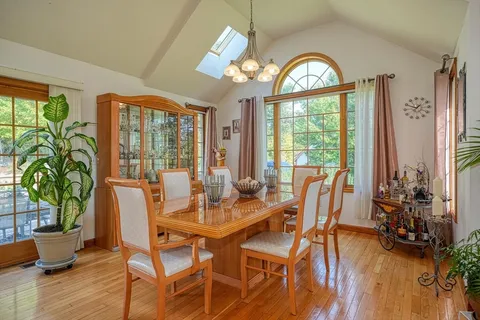 a view of a dining room with furniture window and wooden floor
