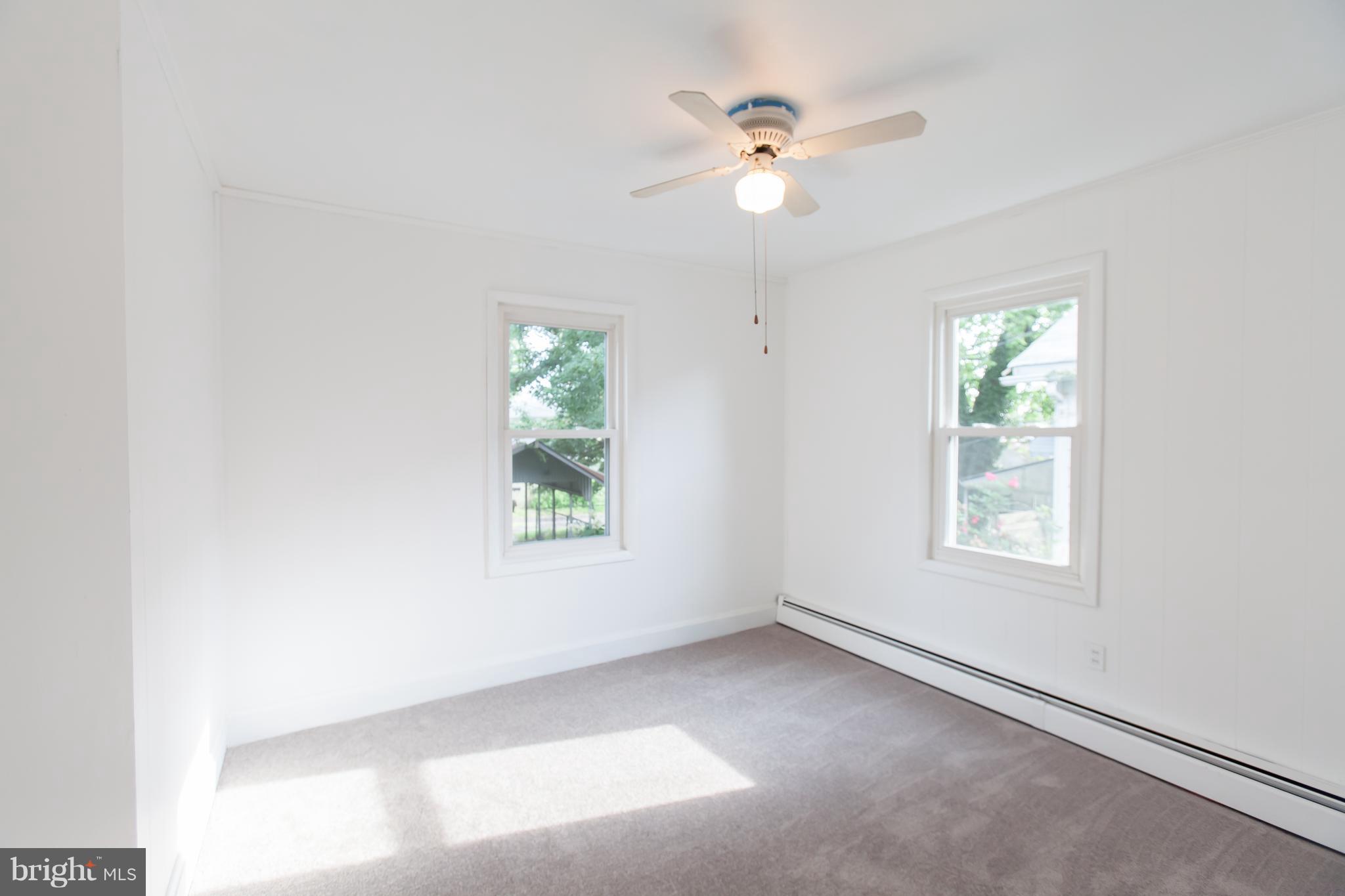 6907 Ridgeway Road Baltimore, MD 21222 - Photo 14 of 25 an empty room with windows and fan