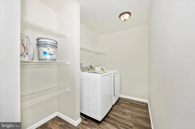 a utility room with cabinets washer and dryer