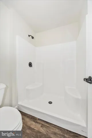 a bathroom with a toilet and a shower