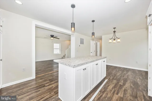 a spacious bathroom with a granite countertop sink and a mirror