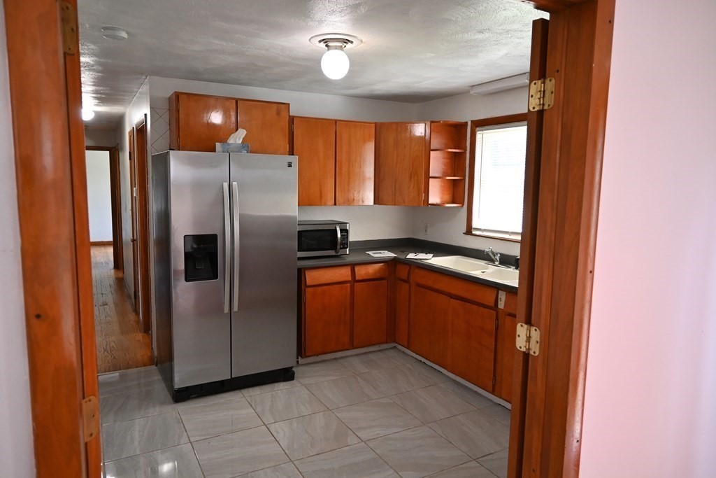 16 Charles Hill Road Holyoke, MA 01040 - Photo 12 of 27 a kitchen with stainless steel appliances granite countertop a refrigerator and a sink
