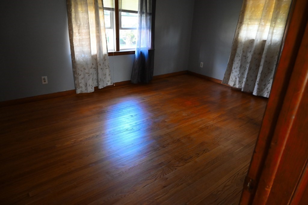 16 Charles Hill Road Holyoke, MA 01040 - Photo 16 of 27 an empty room with wooden floor and windows