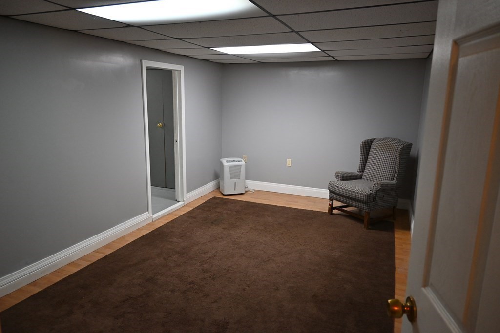 16 Charles Hill Road Holyoke, MA 01040 - Photo 20 of 27 a view of room with chair and wooden floor