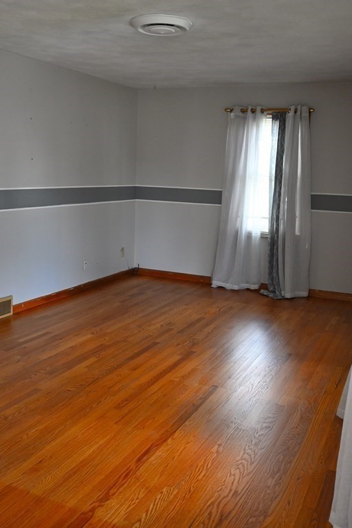 16 Charles Hill Road Holyoke, MA 01040 - Photo 7 of 27 an empty room with wooden floor and windows