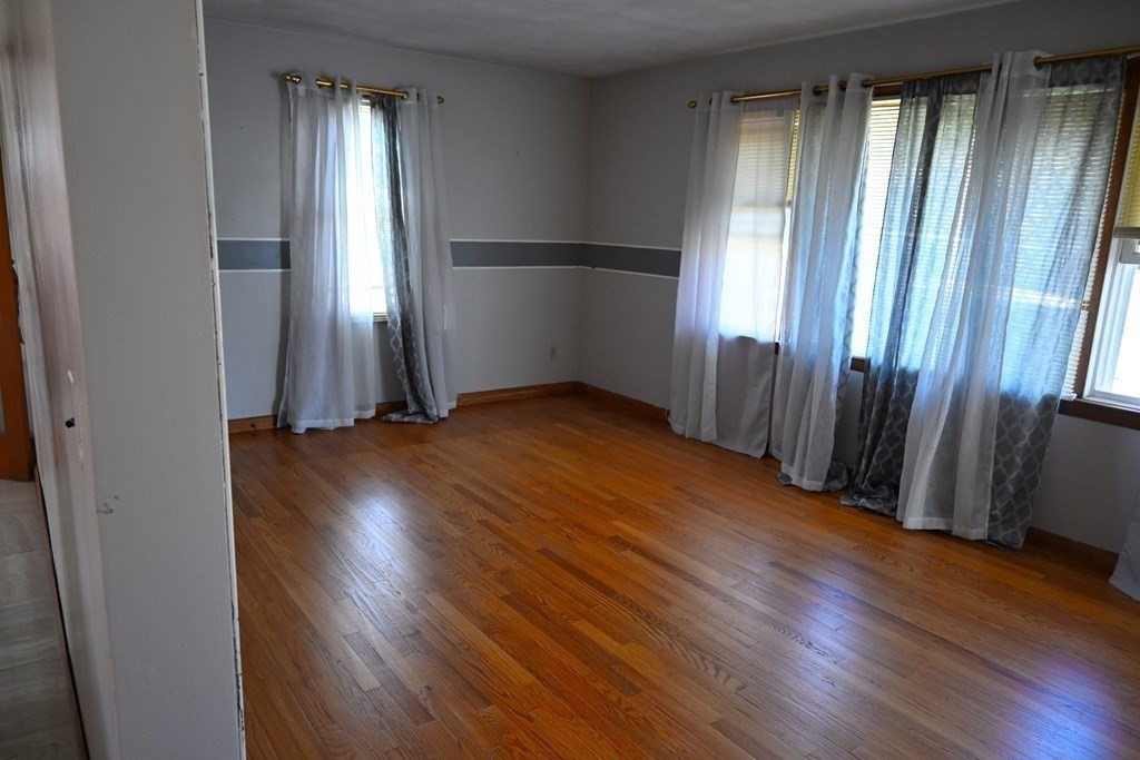 16 Charles Hill Road Holyoke, MA 01040 - Photo 9 of 27 an empty room with wooden floor and a window