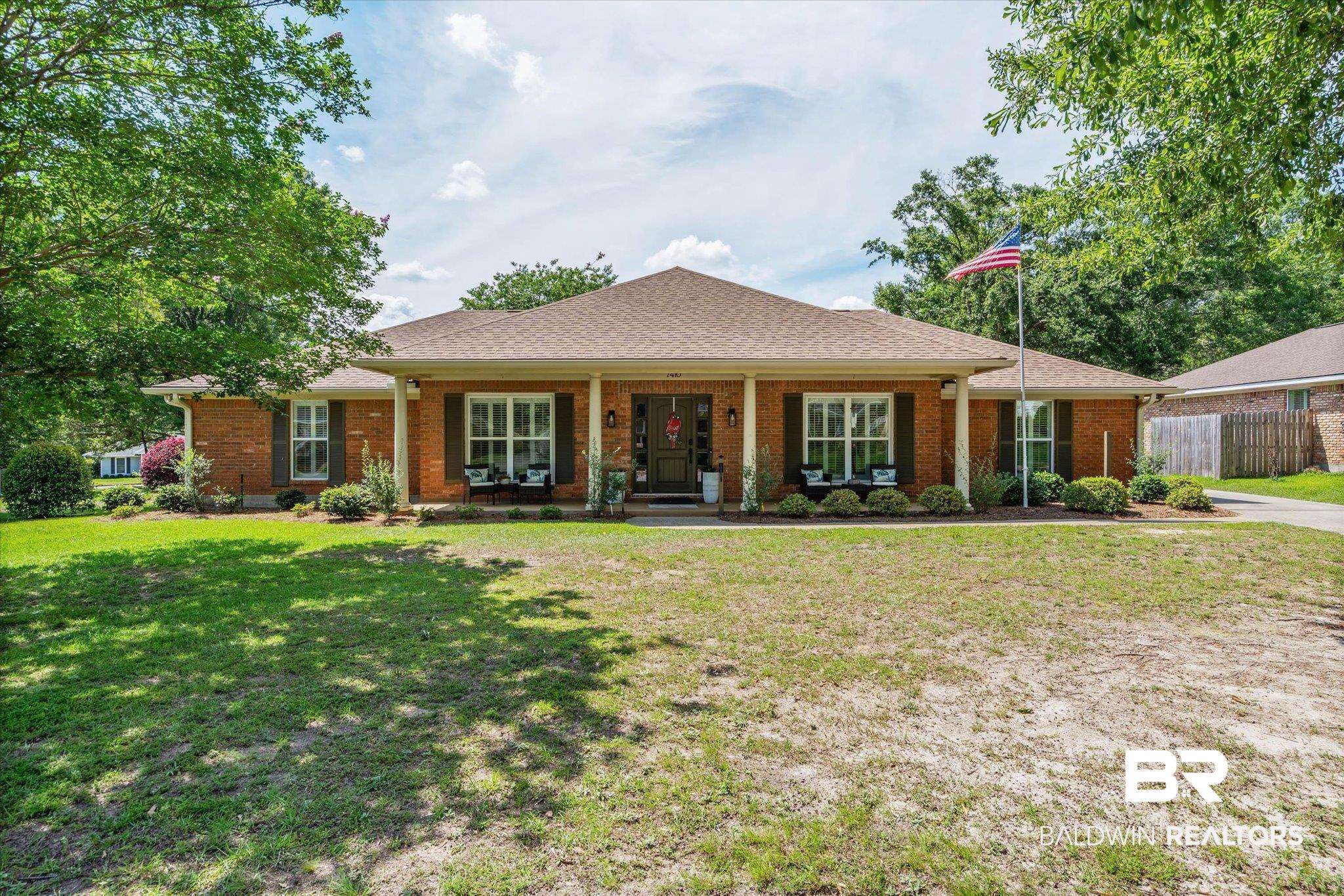 7410 Smithfield Road East Mobile, AL 36695 - Photo 21 of 24 Brick exterior with a covered front porch featuring white pillars and dark shutters