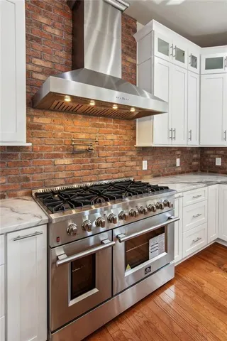 a stove top oven sitting inside of a kitchen