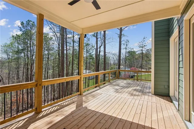 a balcony with wooden floor table and chairs